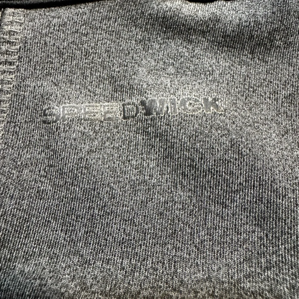 Reebok charcoal gray athletic leggings, mesh patterned detailing on side, S.